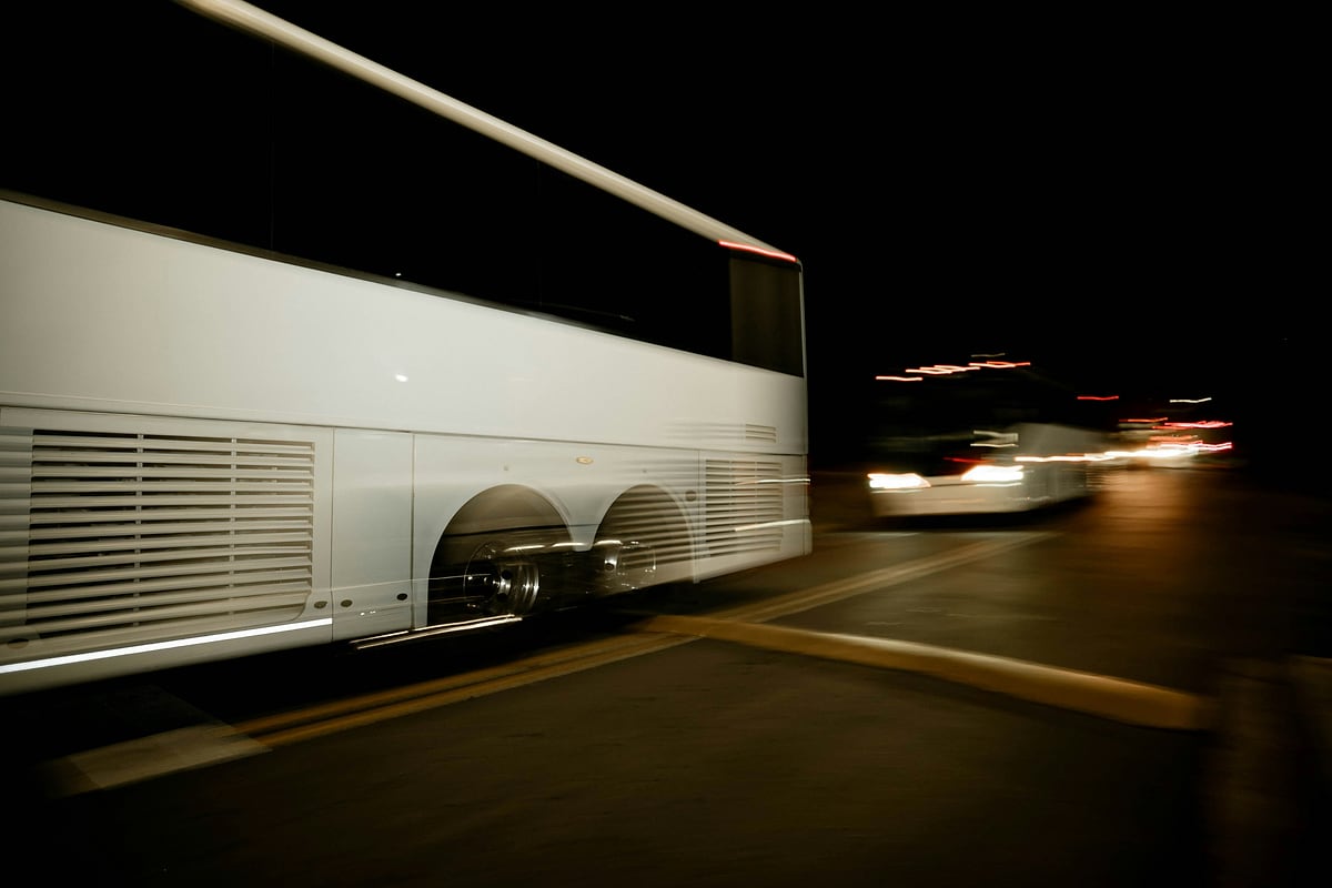 A white coach on the move at night