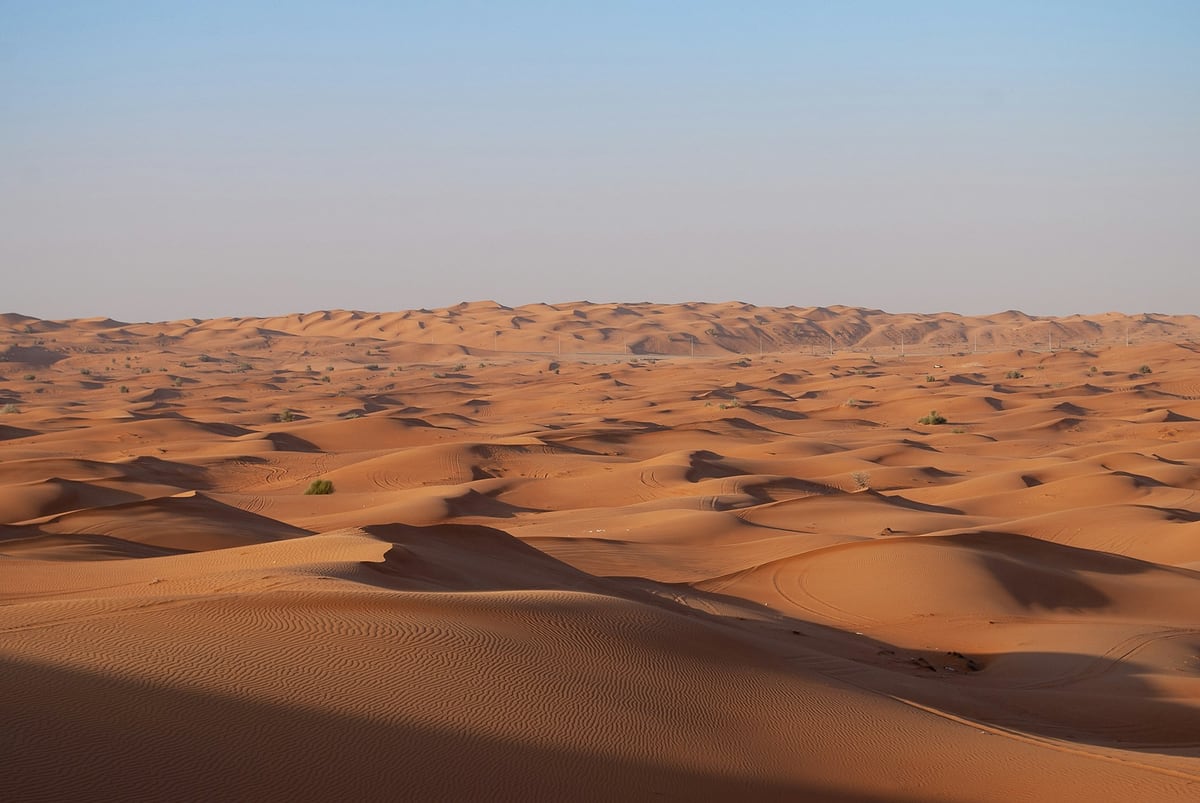 Rolling sand dunes in the desert outside Dubai under a clear sky