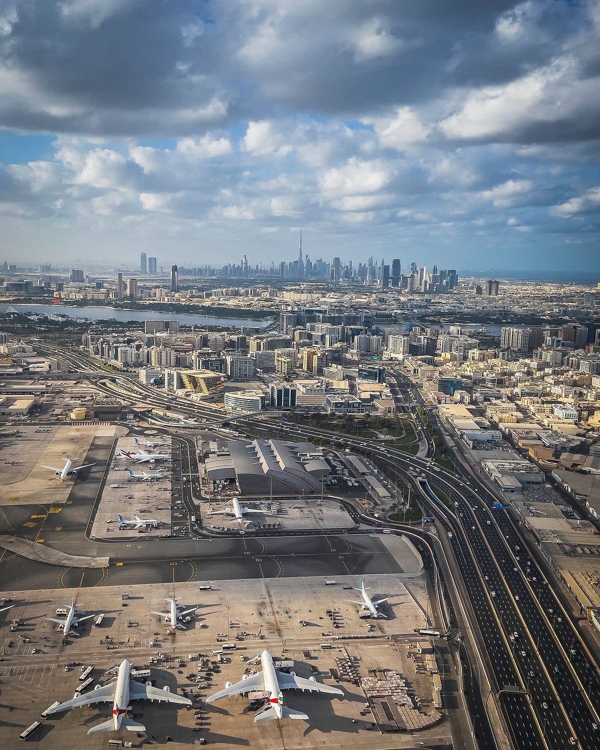 Aerial view of Dubai International Airport with the city stretching to the skyline