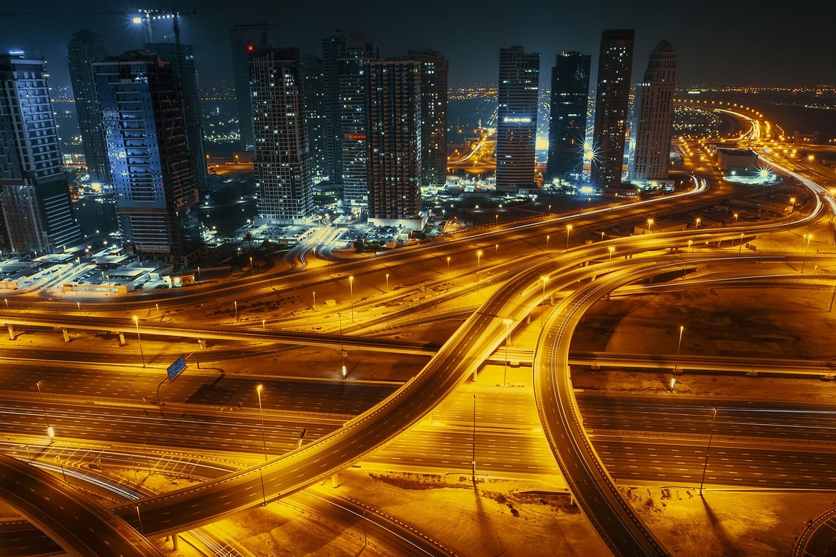 Aerial view of Dubai’s highway interchanges glowing at night