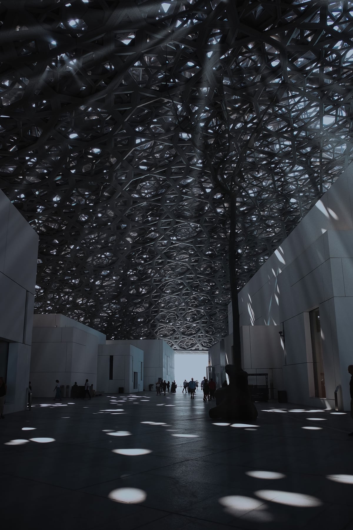 Sunlight falling through the patterned dome of the Louvre Abu Dhabi